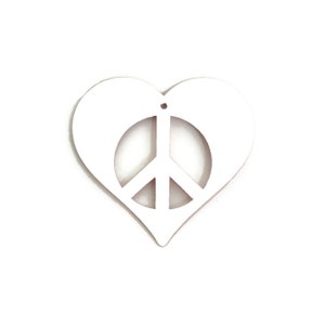 May include: White wooden heart-shaped ornament with a peace sign cutout in the center.