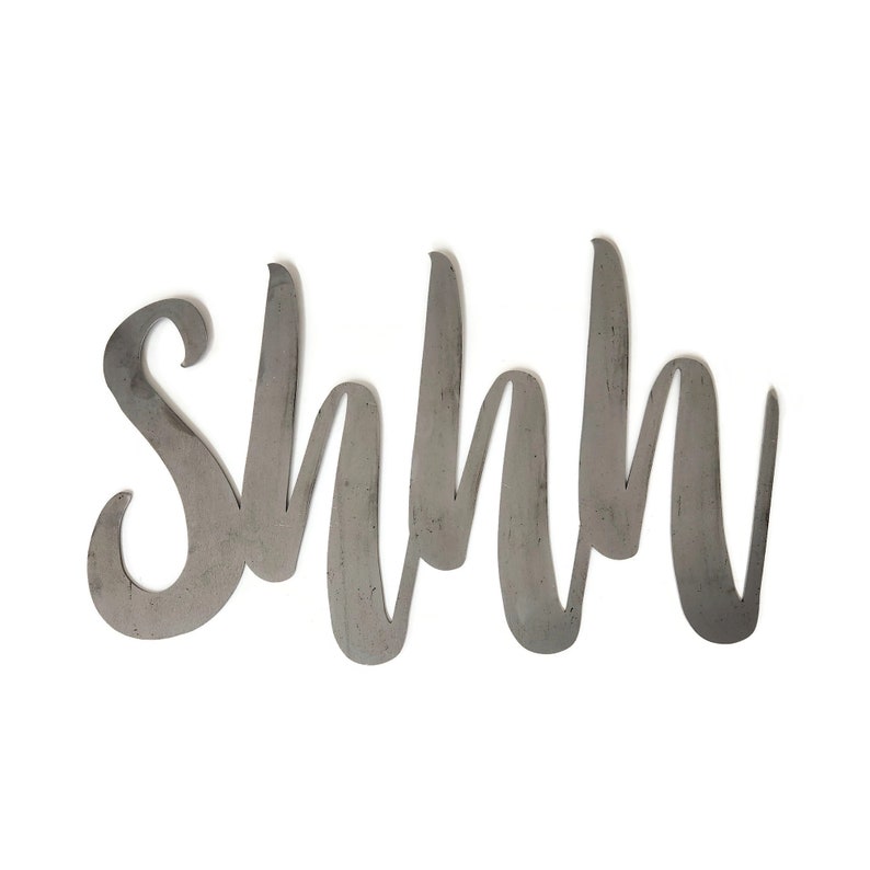 May include: Metal wall decor with the word "Shhh" written in a cursive font.