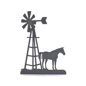 Op de afbeelding: Zwarte metalen silhouet van een windmolen en een paard, een rustiek boerenerf.