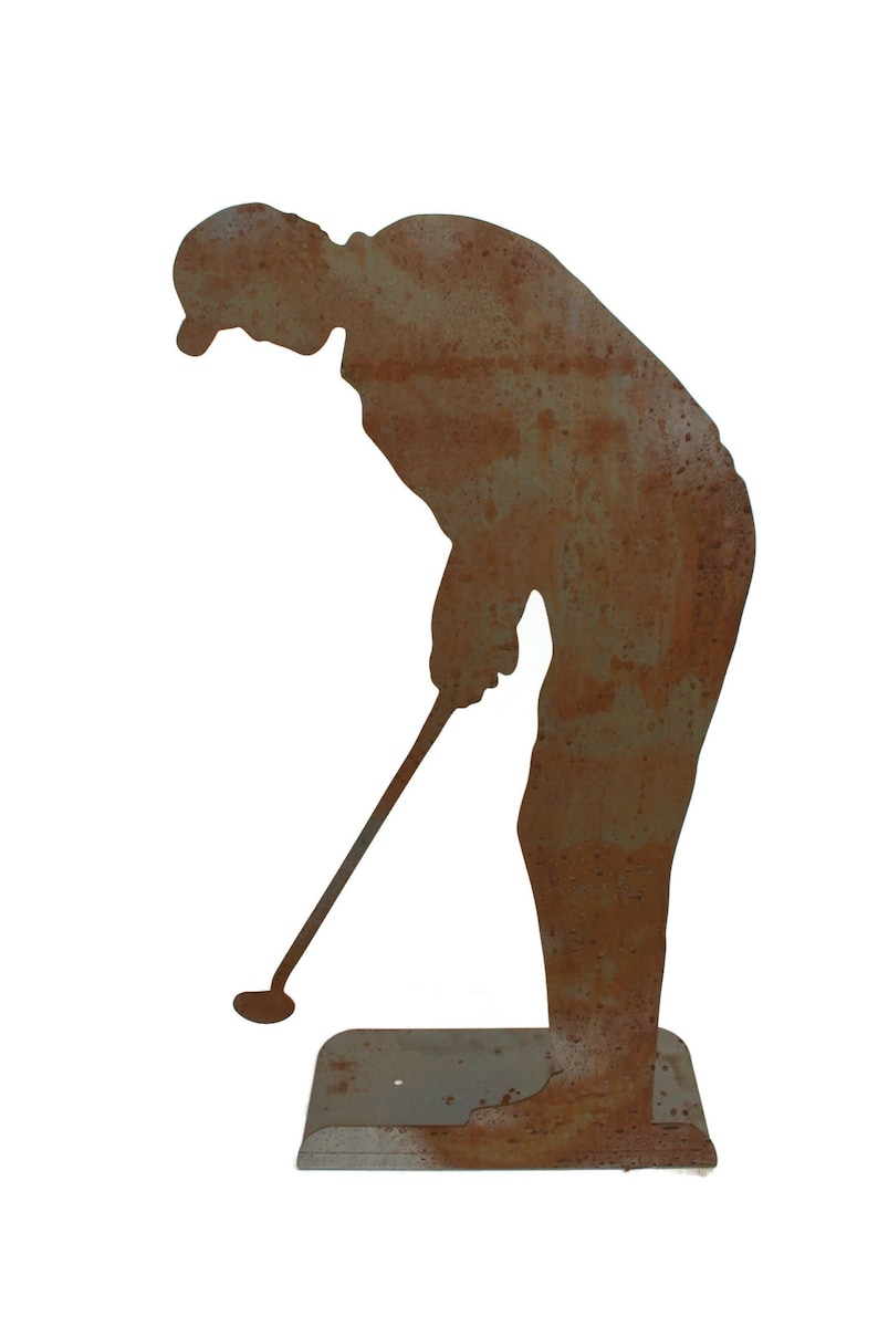May include: A weathered metal silhouette of a golfer in a putting stance. The figure is bent over, holding a golf club, with a rusty brown finish. The base is a rectangular shape, also with a rusted appearance. Ideal for garden decor.