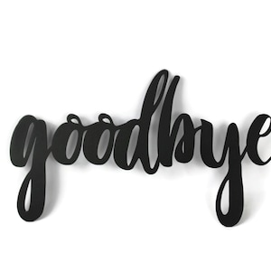 May include: Black metal wall decor with the word "goodbye" written in a cursive font.