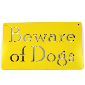 May include: Yellow metal sign with the text "Beware of Dogs" cut out in the metal.