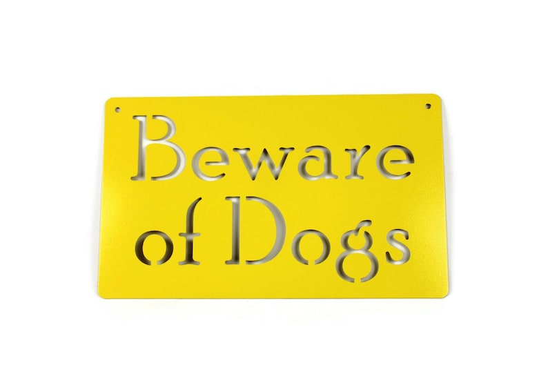 May include: Yellow metal sign with the text "Beware of Dogs" cut out in the metal.