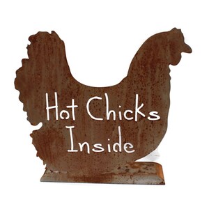 May include: A rusty metal chicken silhouette with the words "Hot Chicks Inside" written in white paint.