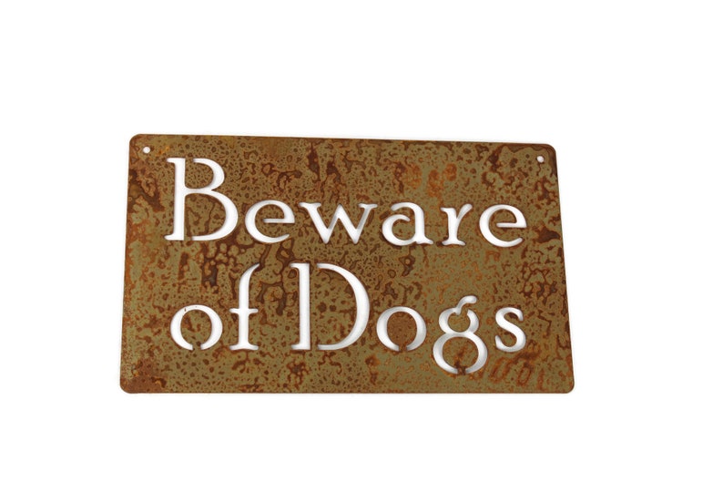 May include: A rusty metal sign with the words "Beware of Dogs" in white lettering.