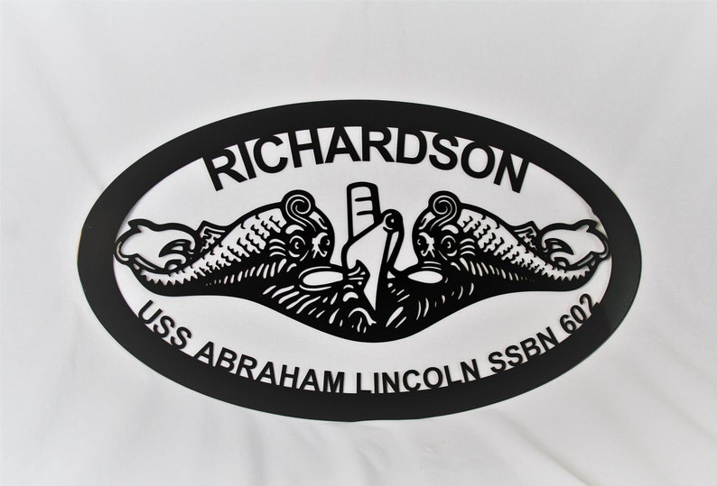 May include: Black metal oval sign with the text "RICHARDSON USS ABRAHAM LINCOLN SSBN 602" and a stylized image of a submarine with two dolphins.