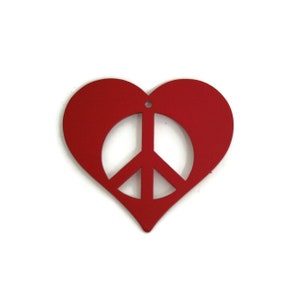 May include: A red heart-shaped ornament with a peace sign cut out in the center.