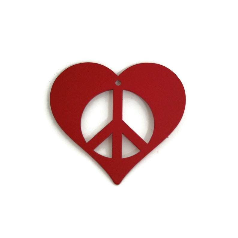 May include: A red heart-shaped ornament with a peace sign cut out in the center.