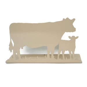 May include: A beige metal cow and calf silhouette wall decor. The cow and calf are standing side by side in a grassy field.