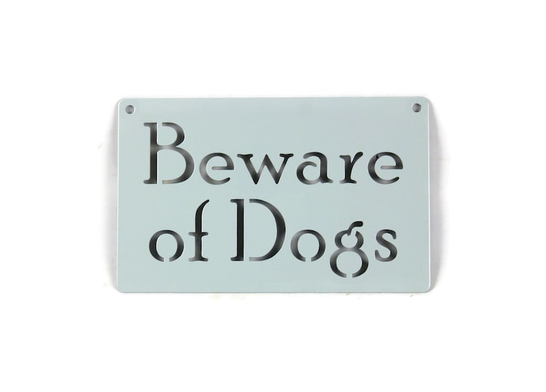 May include: A light blue metal sign with the text "Beware of Dogs" cut out in black.
