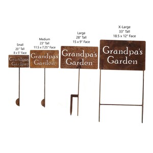 May include: Four brown metal garden signs of varying sizes, each with the words "Grandpa's Garden" in white lettering. Sizes range from 20" tall to 33" tall. The signs are designed to be placed in a garden.