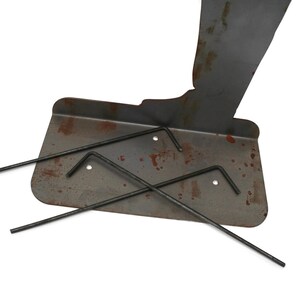 May include: A metal plate with rust spots and three black Allen wrenches. The plate has a curved edge and three holes. The wrenches are different sizes and are arranged on the plate.