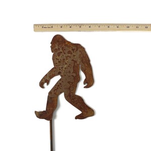 May include: A handmade wooden sign with the text "Welcome to our home" in a handwritten style. The sign is painted white with black lettering and a distressed finish, perfect for farmhouse decor.