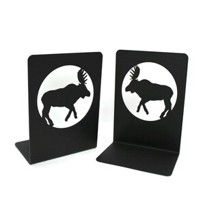 May include: A pair of black metal bookends featuring a silhouette of a moose in a circle. The bookends are a great way to add a touch of rustic charm to your home.