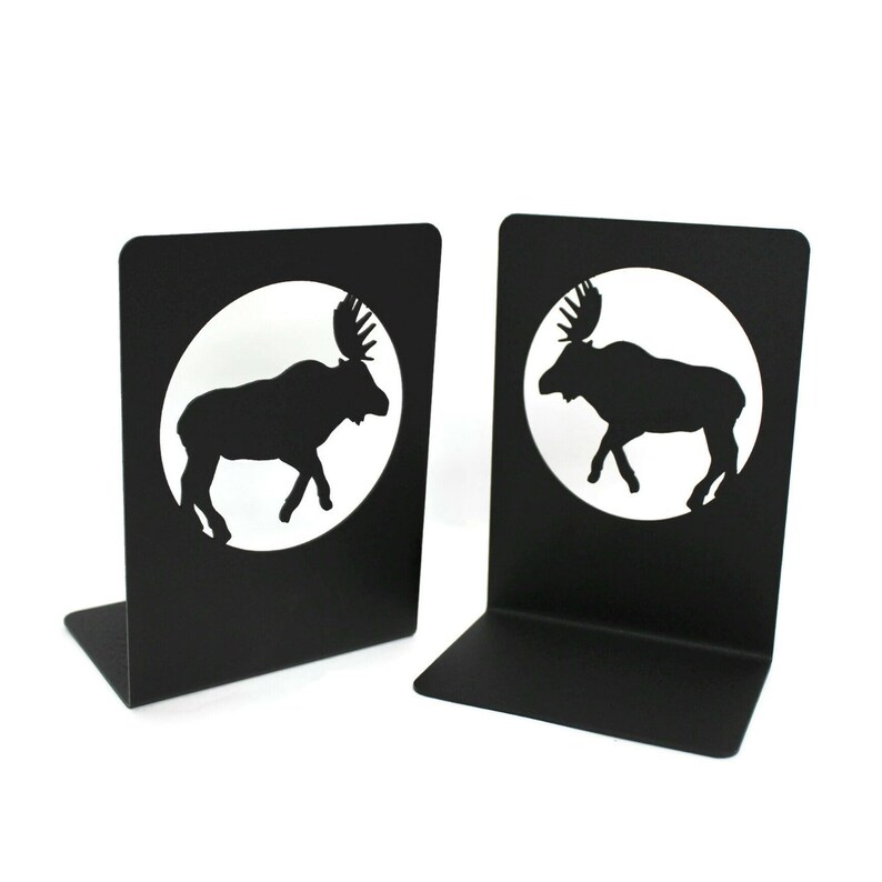 May include: A pair of black metal bookends featuring a silhouette of a moose in a circle. The bookends are a great way to add a touch of rustic charm to your home.