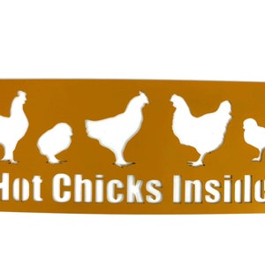 May include: A yellow metal sign with a white silhouette of five chickens and the text "Hot Chicks Inside".