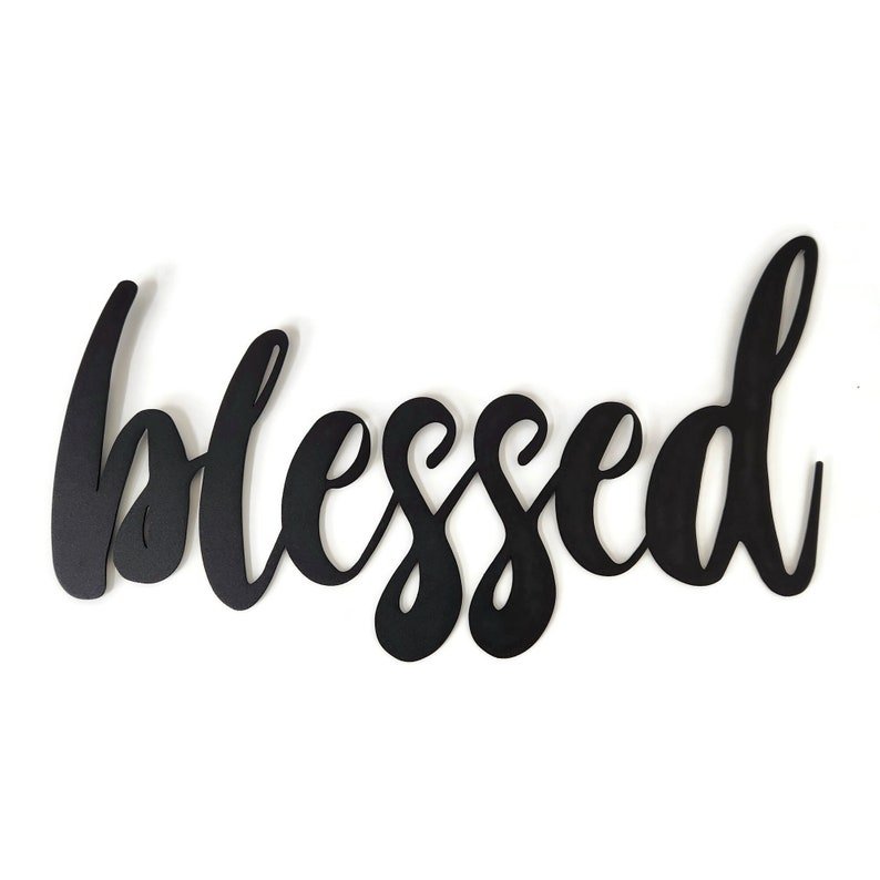 May include: Black wooden sign with the word "blessed" written in a cursive font.