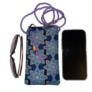 May include: A black and blue patterned phone crossbody bag with a purple rope strap. The bag has a decorative tassel and is next to a pair of sunglasses and a smartphone.