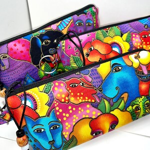 May include: Three colorful zippered pouches with a whimsical animal print design. The pouches feature a variety of colorful animals, including dogs, cats, and birds. The pouches are made of a durable fabric and have a zipper closure.