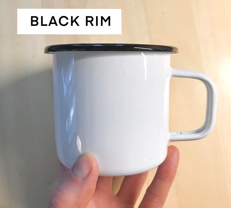 May include: White enamel mug with a black rim and a handle.