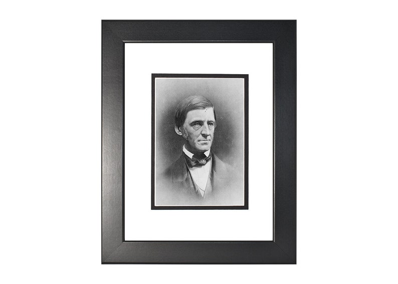 May include: Black and white portrait photograph of a man in a suit and bow tie. The man is looking directly at the camera. The photograph is framed in a black frame with a white mat.