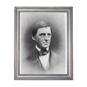 May include: Black and white portrait photograph of a man in a suit and bow tie. The photo is framed in a silver frame.