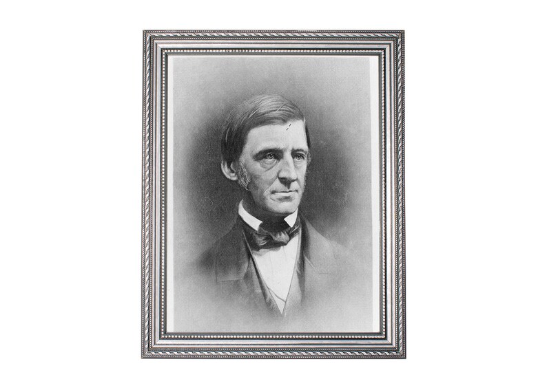 May include: Black and white portrait photograph of a man in a suit and bow tie. The photo is framed in a silver frame.