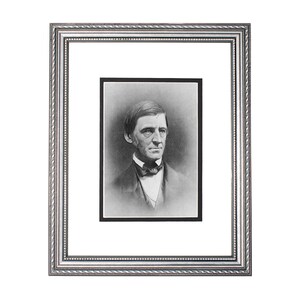 May include: A black and white portrait of a man in a framed photograph. The man is wearing a dark suit with a white shirt and a bow tie. He has a serious expression on his face.
