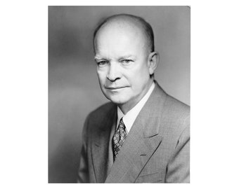 May include: A black and white portrait of a man wearing a suit and tie. He has a serious expression on his face.