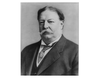 May include: A black and white portrait of a man with a thick mustache wearing a suit and tie.