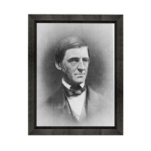 May include: Black and white portrait of a man in a framed photograph. The man is wearing a dark suit with a white shirt and a bow tie. He has a serious expression on his face.