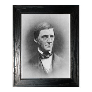 May include: Black and white portrait photograph of a man in a suit and bow tie. The photograph is framed in a black wood frame.