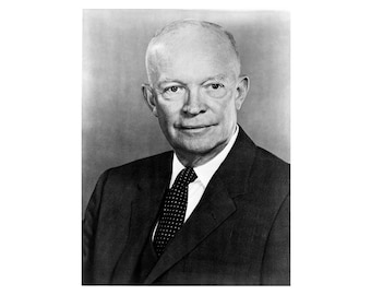 May include: A black and white portrait of a man wearing a suit and tie. He has a serious expression on his face.