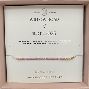 May include: A delicate gold-filled bracelet with pink and gold beads, presented on a card that reads "Willow Road CA" and "11-01-2025". The card also features Morse code and the text "14k Gold Filled Morse Code Jewelry".