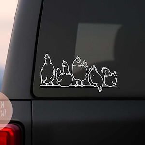 May include: A white vinyl decal featuring a line of six chickens perched on a horizontal line. The chickens are depicted in a simple, minimalist style, with varying poses and sizes. The decal is applied to the window of a black vehicle.