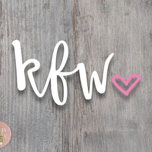 May include: White cursive lettering spelling "kfw" with a pink heart to the right.