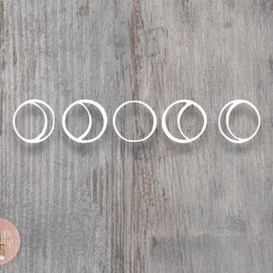 May include: A white vinyl decal featuring five circular moon phase icons arranged in a horizontal row. The design displays the waxing crescent, first quarter, full moon, last quarter, and waning crescent phases in a simple line art style.