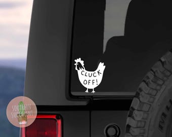 May include: A white vinyl decal applied to a vehicle window, featuring a stylized silhouette of a chicken with the text CLUCK OFF! printed in black lettering on its body. The design is simple, with a clear outline of the bird and its comb.