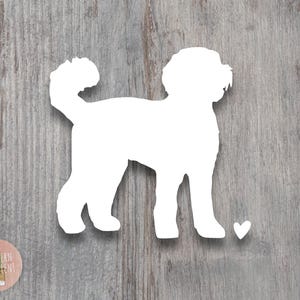 May include: White silhouette of a dog with a heart shape below it. The dog is standing on a wood grain background.