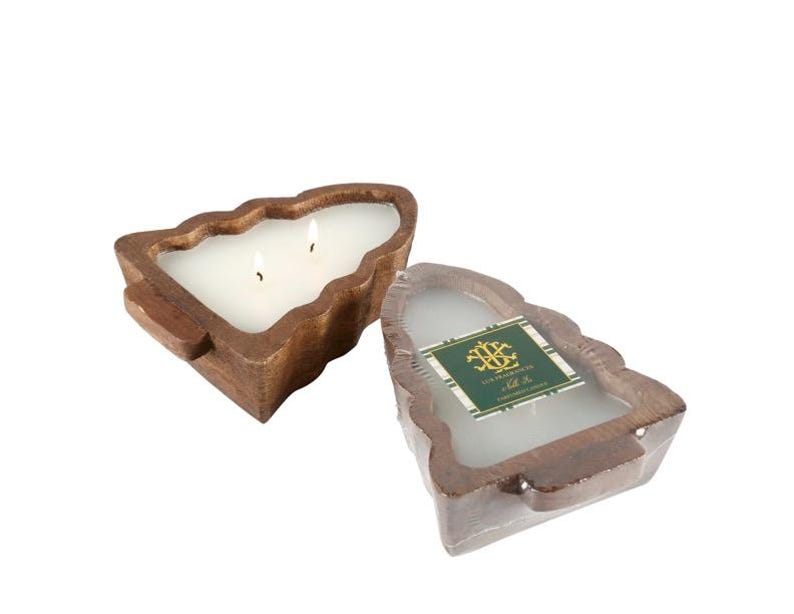 May include: Two-wick candle in a tree-shaped wooden container. The candle is white, and the wooden container is a warm brown color. The candle is next to a similar candle in plastic wrap with a green and gold label.