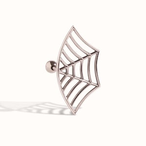 May include: A silver-toned metal ear stud featuring a flat, fan-shaped spider web design. The jewellery piece includes a straight post with a small, round ball backing, showcasing a detailed, open-work web pattern with curved outer edges.