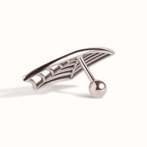 May include: A silver-toned metal body jewellery piece featuring a curved, fan-like shape with an openwork spider web design. The piece includes a straight post attached to the back, ending in a small, smooth, spherical ball closure.