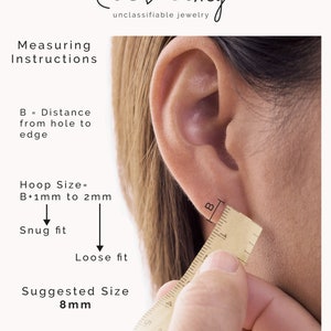 May include: Diagram showing how to measure your ear for hoop earrings. The image shows a ruler measuring the distance from the ear piercing to the edge of the earlobe. The text reads "B = Distance from hole to edge", "Hoop Size = B+1mm to 2mm", "Snug fit", "Loose fit", and "Suggested Size 8mm".