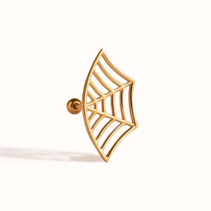 May include: A gold-toned ear stud featuring a flat, fan-shaped spider web design. The jewellery piece includes a thin, curved metal frame with internal web-like detailing and a small, round ball backing attached to a straight post for secure fastening.