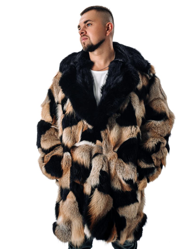 May include: A long, brown, black, and white fur coat with a large hood. The coat is made of different types of fur, creating a patchwork design.