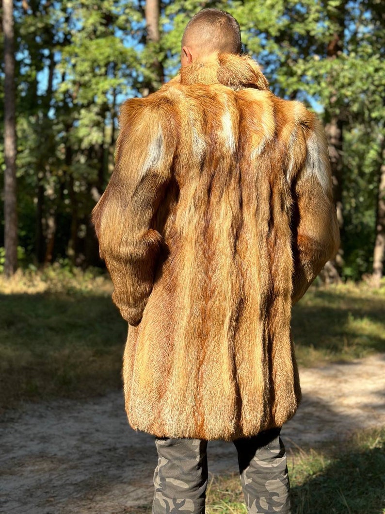 May include: A long, brown fur coat with a high collar. The coat is made of fox fur and has a soft, luxurious feel.