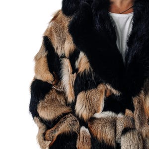 May include: A black and brown patterned fur coat with a large black fur collar.