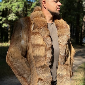 May include: A long, brown fur coat with a large collar. The coat is made of fox fur and has a striped pattern.