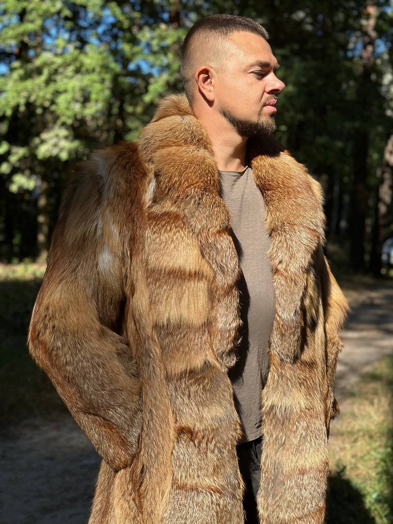 May include: A long, brown fur coat with a large collar. The coat is made of fox fur and has a striped pattern.