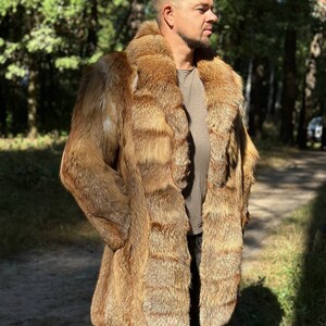 May include: A long, brown fur coat with a collar. The coat is made of fox fur and has a natural, wild look.